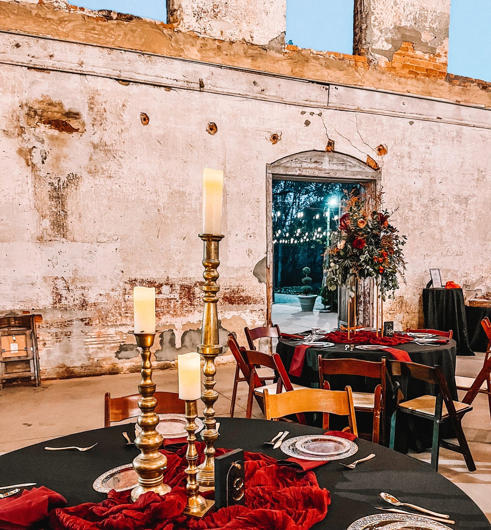 A styled tablescape with brass candlesticks and layered linens
